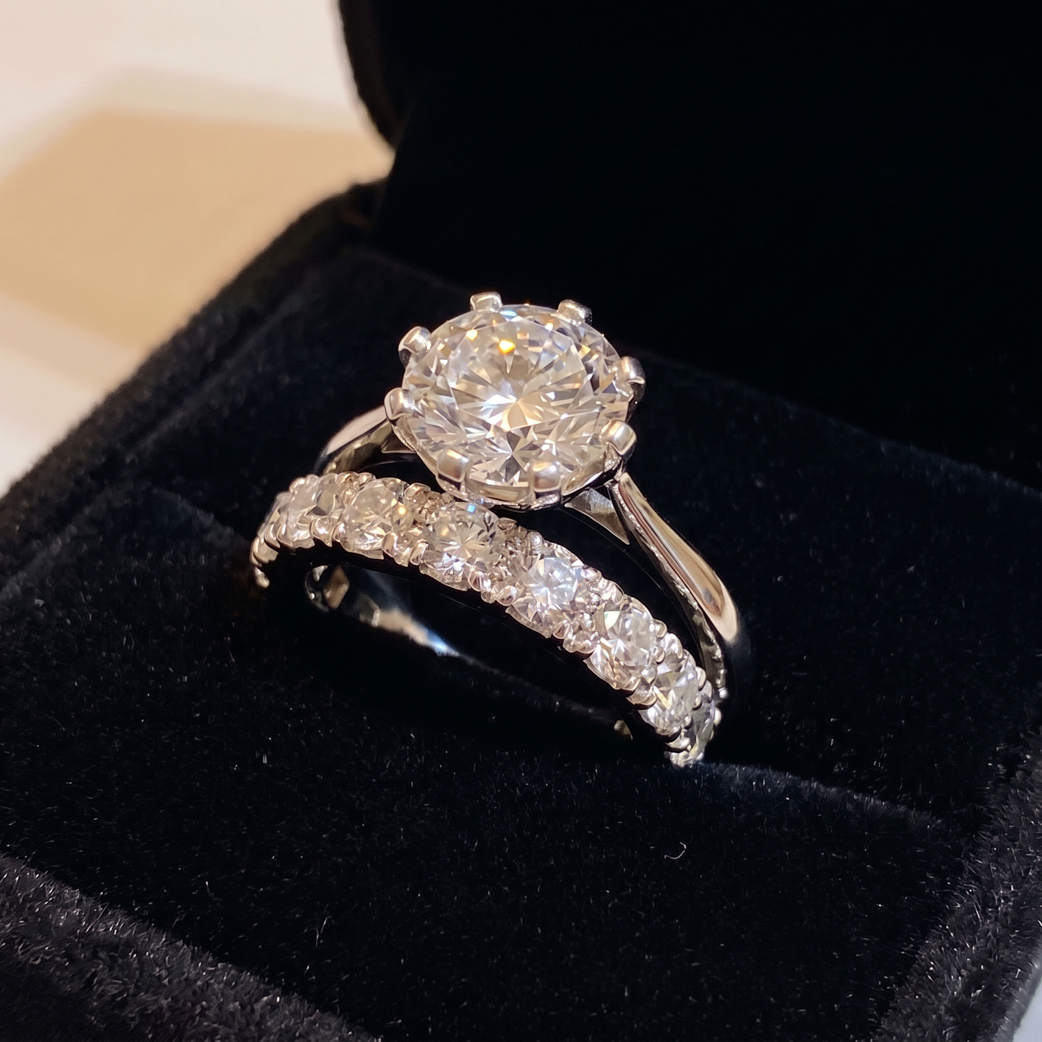 Diamond solitaire with a diamond band in a black box